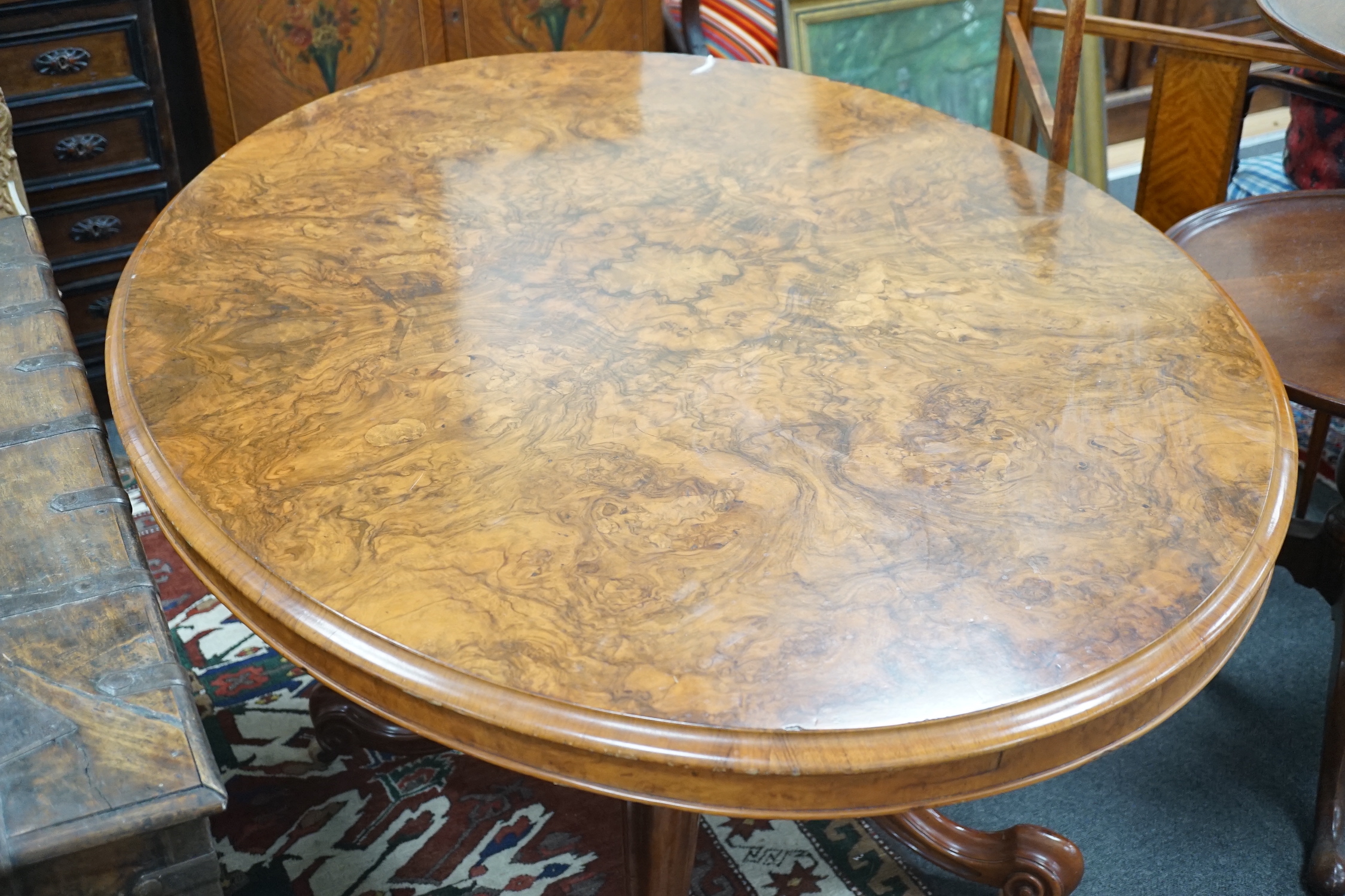 A Victorian figured walnut oval tilt top loo table, width 136cm, depth 102cm, height 74cm